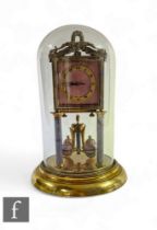 An early 20th Century 365 day mantle clock, the square pink guilloche enamel dial on reeded