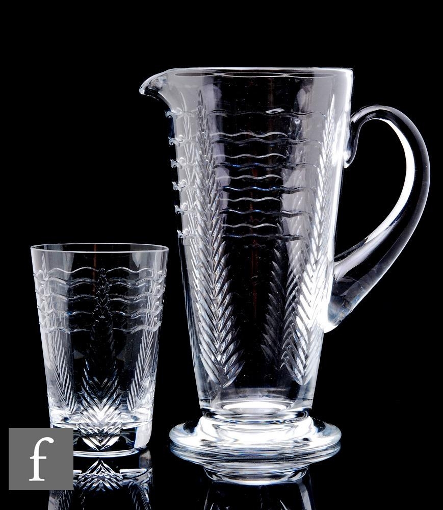 A 20th Century Webb Corbett glass jug of footed form with applied loop handle, cut with stylised