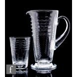 A 20th Century Webb Corbett glass jug of footed form with applied loop handle, cut with stylised