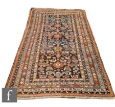 An Azerbaijan Caucasian Pirebedit rug, the central panel with a series of five floral rosettes