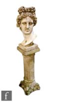 A reconstituted stone bust of Apollo, raised on a Corinthian column pedestal.