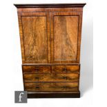 A 19th Century mahogany and flame mahogany linen press, the double door revealing five fitted pull