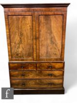 A 19th Century mahogany and flame mahogany linen press, the double door revealing five fitted pull