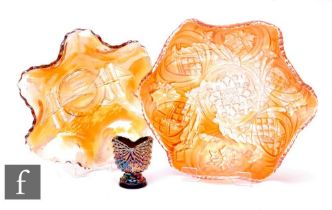 Three pieces of early 20th Century Carnival glass, a bowl with frill rim by Millersburg, relief