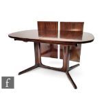 A Robert Heritage for Archie Shine rosewood  dining table, the oval top raised on pillar supports,