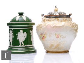 A Doulton Burslem biscuit barrel, height 19cm, together with a green glazed relief moulded tobacco