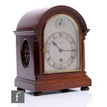 A small Edwardian mahogany cased bracket clock, by W Potts & Sons Ltd Leeds, arched silvered dial