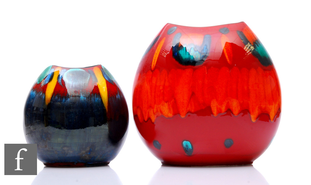 Two later 20th Century Poole Pottery pillow vases, decorated with abstract patterns over the red and