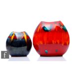 Two later 20th Century Poole Pottery pillow vases, decorated with abstract patterns over the red and