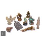 A collection of 20th Century South East Asian bronze charms, to include a running tiger, sage with a