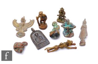 A collection of 20th Century South East Asian bronze charms, to include a running tiger, sage with a