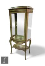 A 20th Century French gilt metal mounted green painted vitrine, painted with garlands of flowers,