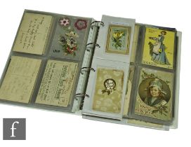 An album of Edwardian postcards, early greetings, valentines, applique cards, humour, Christmas