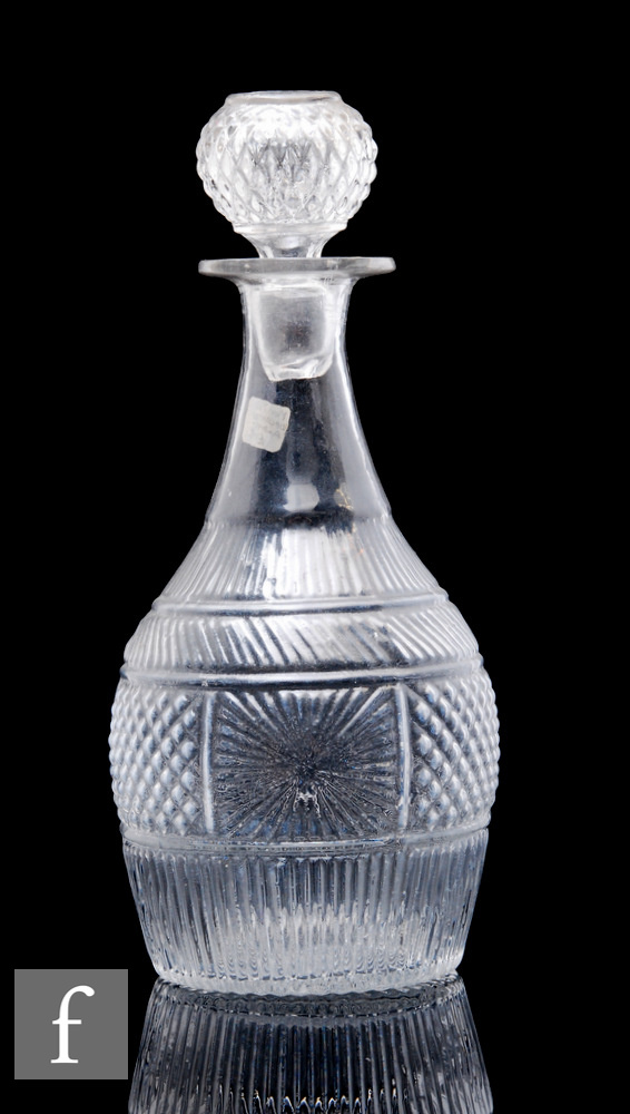 A late 19th Century American press moulded decanter of shouldered ovoid form with repeat moulded