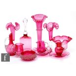 A collection of late 19th to early 20th Century ruby or cranberry glass to include frill rim vases