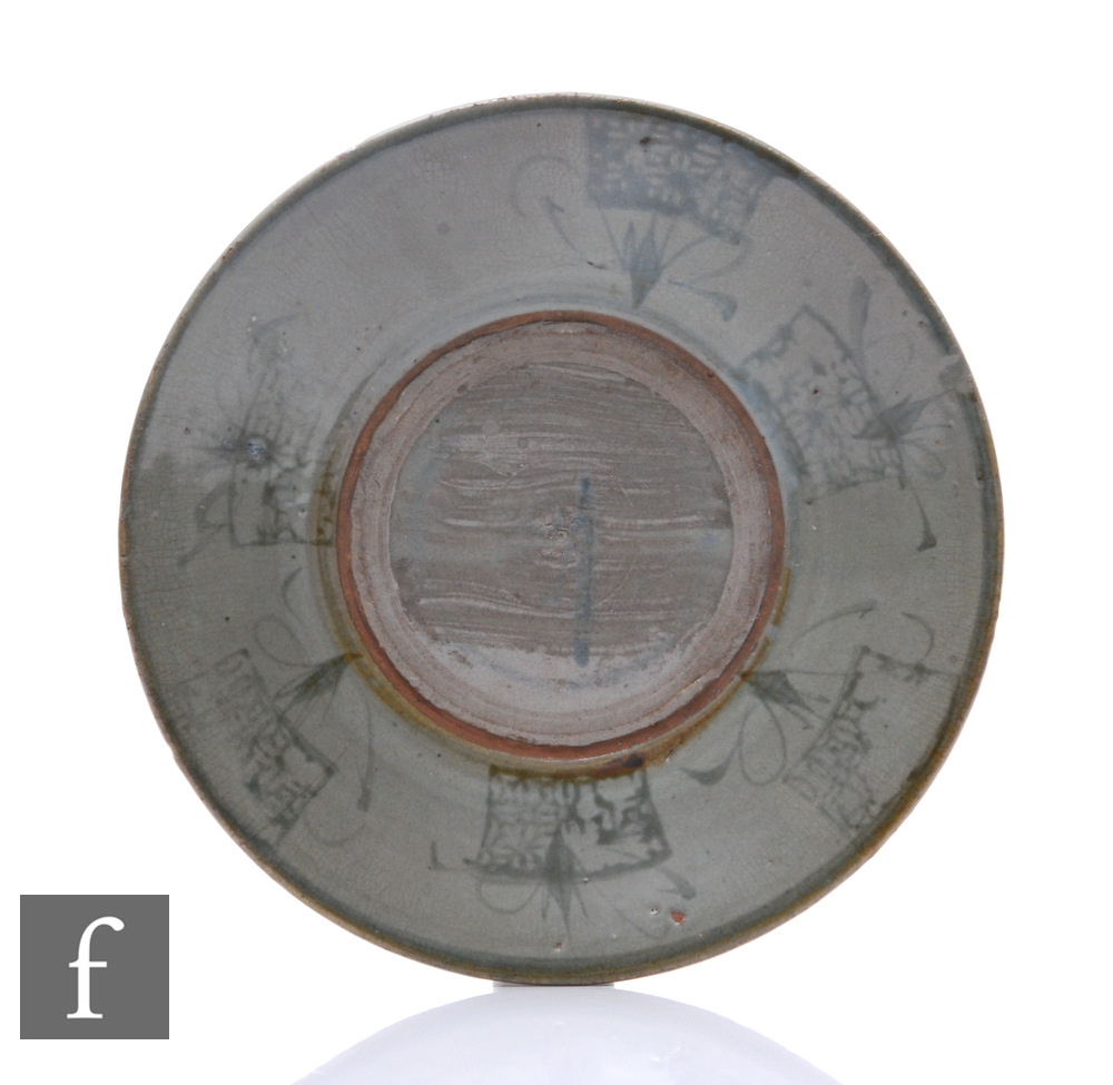 A Chinese Tang Dynasty celadon dish, of circular form with gently sloped sides, with blue abstract