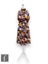 A 1960s vintage silk sleeveless shift dress, with high collar neck and original tie waist belt,