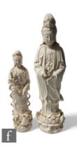 Two Chinese Blanc-de-chine figures of Guanyin, both in standing position, raised on lotus base, each