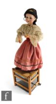 A 1920s automaton of an Armand Marseille 390 doll as a Gypsy girl wearing lace edge blouse and