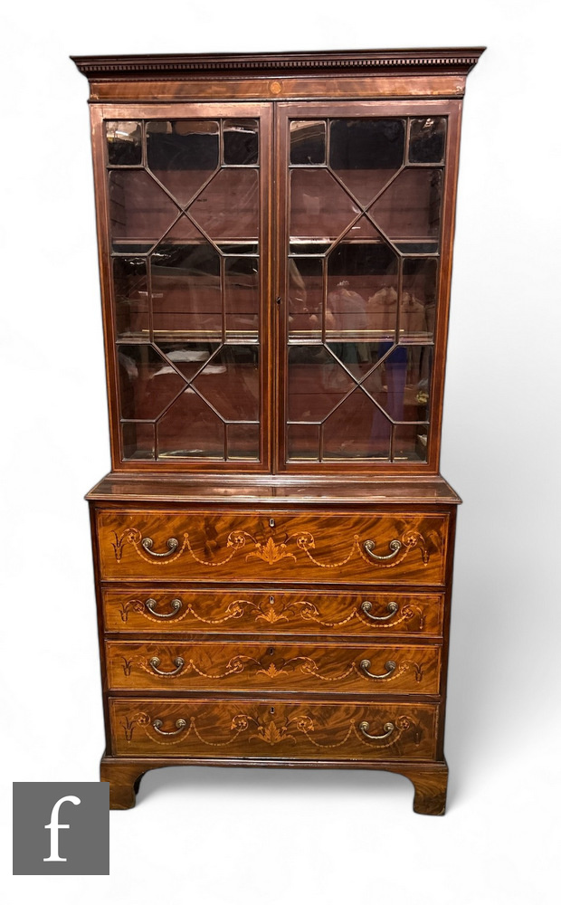 A George III mahogany and inlaid secretaire bookcase, the mahogany and boxwood strung base, inlaid
