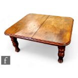 A Victorian extending mahogany dining table , the double edge top over a plain frieze on turned