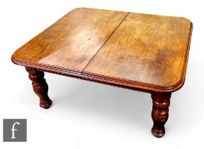 A Victorian extending mahogany dining table , the double edge top over a plain frieze on turned