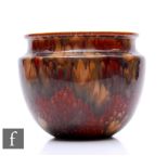 A Ruskin treacle glazed jardinere, of ovoid form with everted rim, glazed throughout with rich