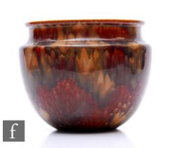 A Ruskin treacle glazed jardinere, of ovoid form with everted rim, glazed throughout with rich