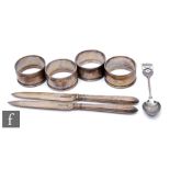 A small collection of silver hallmarked items, to include four napkin rings, two knives and a