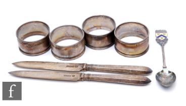 A small collection of silver hallmarked items, to include four napkin rings, two knives and a