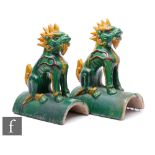 A pair of Ming Sancai styl roof tiles, the arched tile surmounted by a seated shishi lion, in