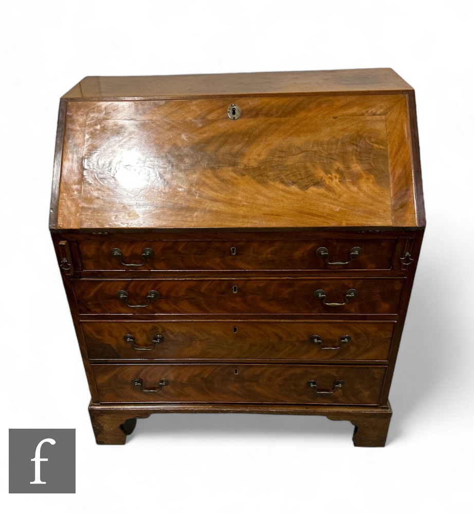 A 19th Century mahogany bureau, the fall front enclosing an arrangement of drawers, above four