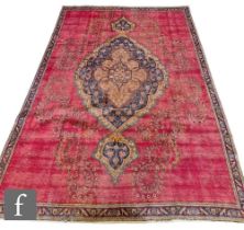 A Turkish Oushak rug, the red ground with central floral design picked out in ochre and blue,