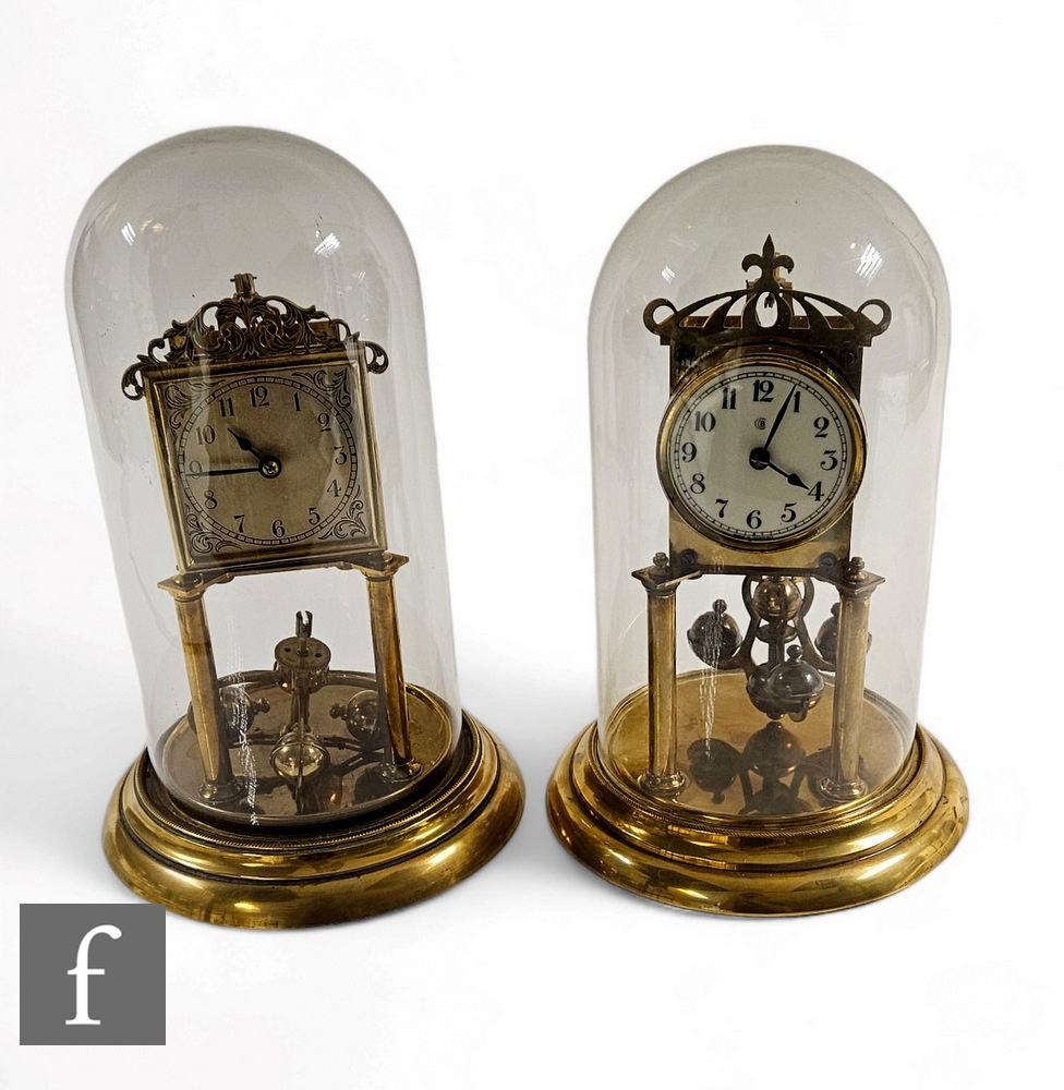 A early 20th Century brass 365 day mantle clock, Arabic circular dial, in glass dome on stepped