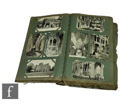 A large Edwardian album of postcards, subjects include cathedrals, churches, towns and the Isle of