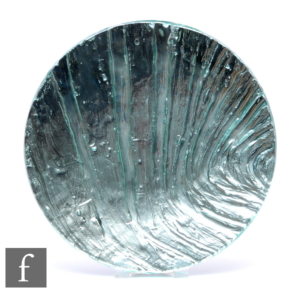A contemporary studio glass charger by Sue Parry of shallow circular form with an internal blue wave