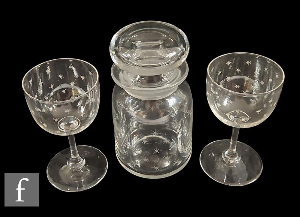 A pair of Whitefriars wine glasses, each with cup bowl finely engraved with stars above a plain stem