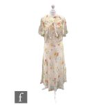 A 1930s vintage sleeveless dress, with bias long skirt in a cream crepe with stylised pink and