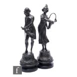 A pair of 19th Century French spelter figures of a lady with a basket and her suitor with a