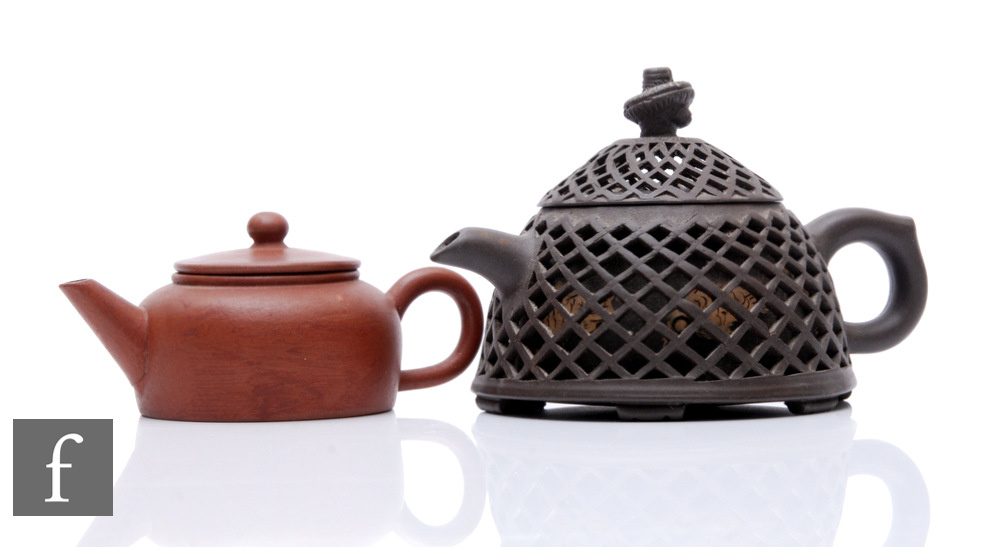 Two Chinese Yixing teapot, the first as double-cased reticulated example painted with fish to the
