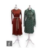 A 1970s vintage Jersey Ware knitted dress with long sleeves, button up detail to the green, black