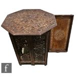 A late Victorian carved hardwood octagonal occasional table, richly decorated with vines and grapes,