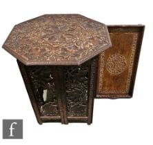 A late Victorian carved hardwood octagonal occasional table, richly decorated with vines and grapes,