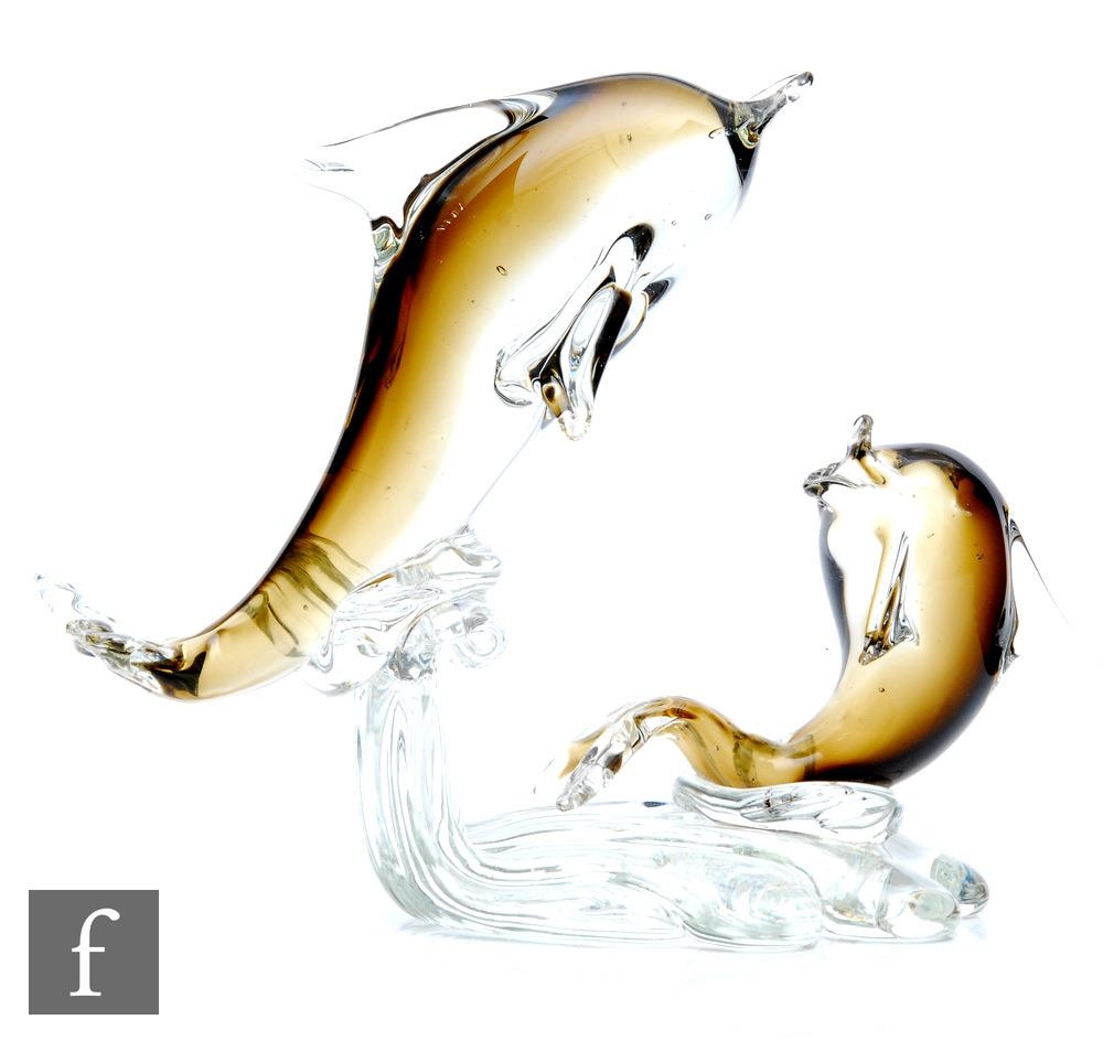 A 20th Century, possibly Murano, glass sculpture modelled as stylised dolphins leaping over a