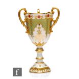 A Coalport porcelain 'Jewelled' pedestal three-handled pedestal goblet, circa 1900, the white ground