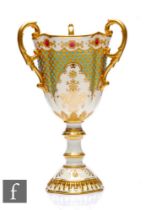 A Coalport porcelain 'Jewelled' pedestal three-handled pedestal goblet, circa 1900, the white ground