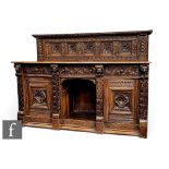 A carved oak Jacobean style sideboard/buffet, the carved panelled back, above plank top and with