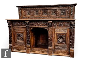 A carved oak Jacobean style sideboard/buffet, the carved panelled back, above plank top and with