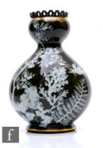 A late 19th Century George Jones Pate-Sur-Pate vase, of rounded baluster form with pierced arcaded