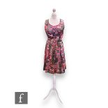 A 1960s vintage sleeveless silk shift dress, with pleated flared skirt and original waist belt,